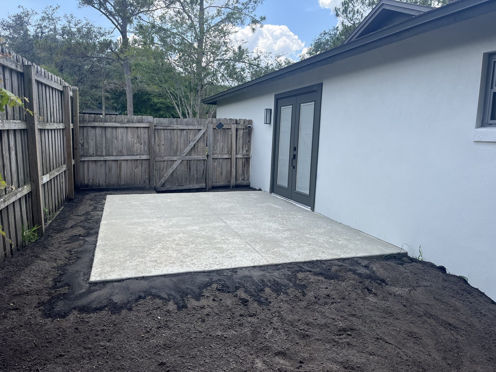 New concrete patio slab poured behind a Central Florida home